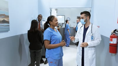 Médecins et infirmiers dans un couloir d'hôpital discutant de questions médicales.
