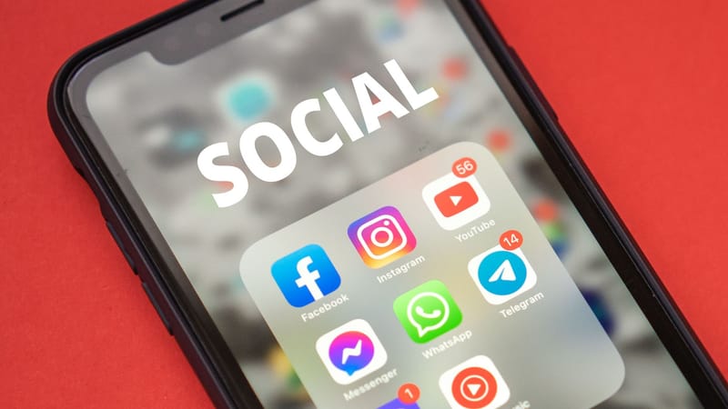 Gros plan sur un smartphone affichant des applications de réseaux sociaux populaires.